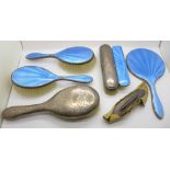 A silver and blue enamel hand mirror and three similar brushes, some enamel a/f, two other silver