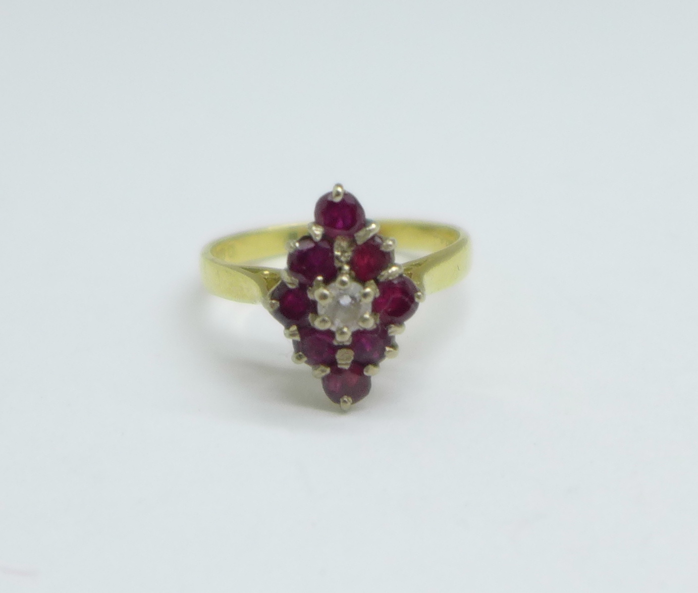 An 18ct gold, ruby and white stone ring, 3.2g, L/M