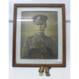 A framed picture of Private Walter Wheeler in the uniform of Durham Light Infantry and a pair of WWI