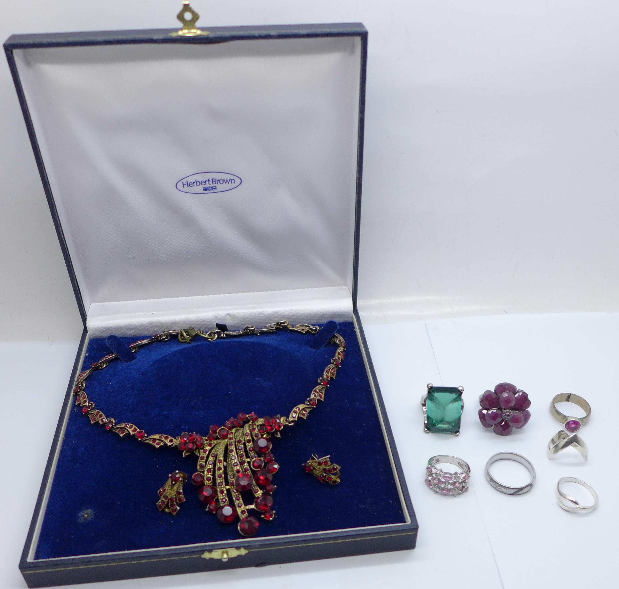 Seven costume rings and a necklace and earring set