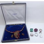 Seven costume rings and a necklace and earring set