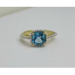 A silver gilt and blue topaz solitaire ring, Q