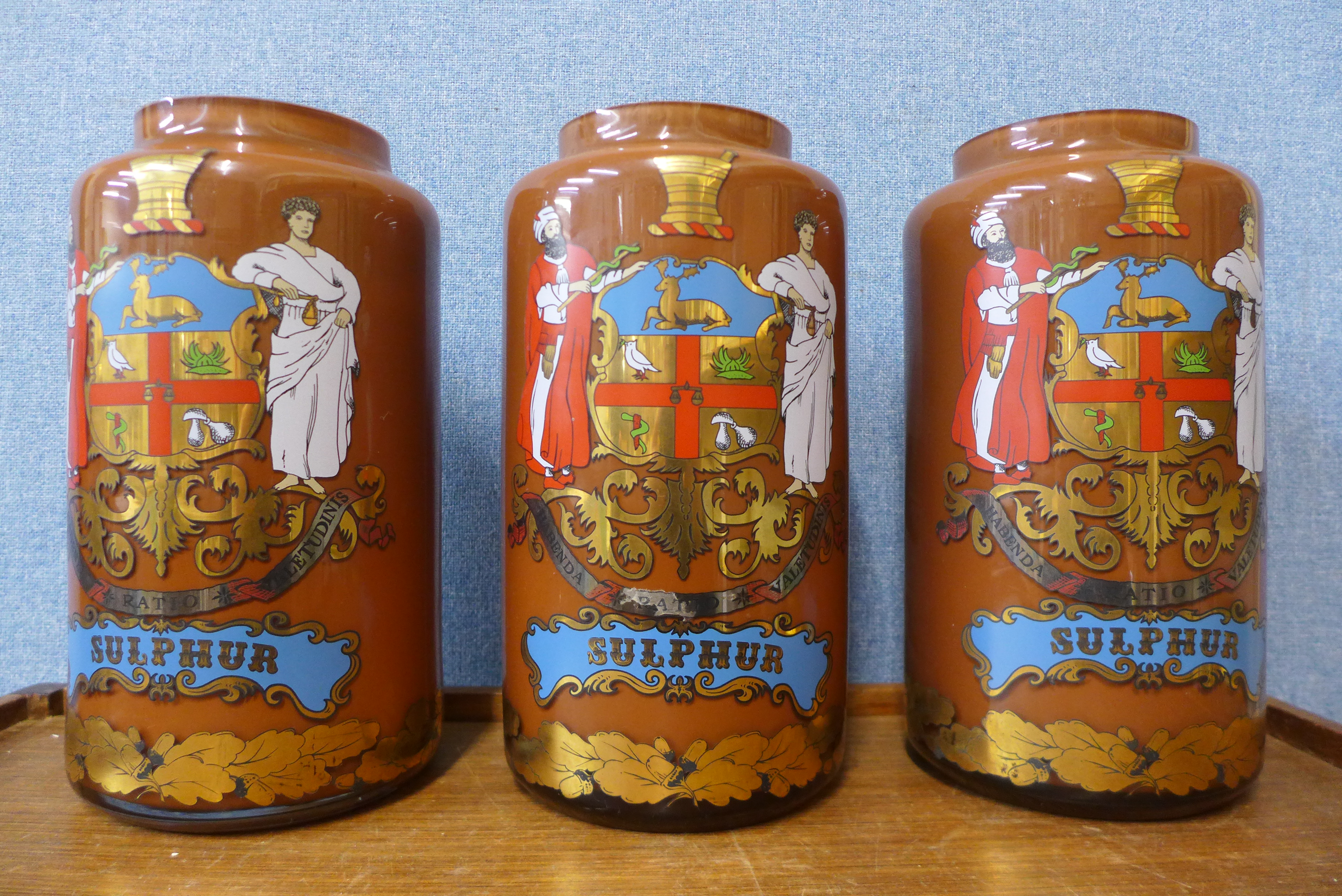 Three painted glass apothecary jars, 30cms h (lacking covers)