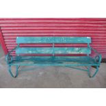 A wrought iron and pine railway platform bench