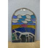 An arched stained glass window pane