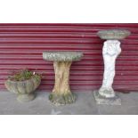 Two concrete bird baths and a planter