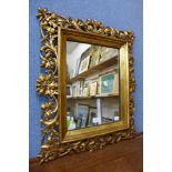 An Italian Florentine carved giltwood and gesso framed mirror, 63 x 52cms