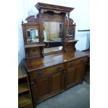 A late Victorian carved walnut mirrorback sideboard