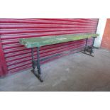 A pine and wrought iron bench