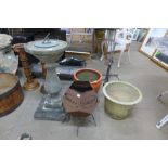 A concrete sun dial, a Bailey wood burner and two planters