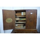 A Cuban mahogany two door table top cigar cabinet, H. Upmann, Habana, 55cms h x 58cms w,