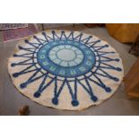 A mid 20th Century cream ground patterned circular rug, 244cms d