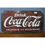 A Coca-Cola enamelled advertising sign, 31 x 58cms
