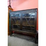 An early 20th Century oak barleytwist two door astragal glazed bookcase, 121cms h, 123cms w, 35cms d