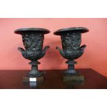 A pair of Italian style cast bronze campana shaped two handled urns, 31cms h