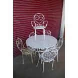 A French style painted metal circular garden table and six chairs