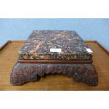 A Chinese carved hardwood and granite topped stand, 12cms h, 33cms w, 33cms d