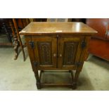 A small carved oak two door cupboard