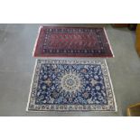 A red ground rug, 155 x 94cms and a blue ground rug, 132 x 92cms
