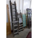 Three stepladders, extending ladders, clothes rails, etc.