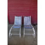 A pair of wrought steel sun loungers