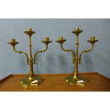 A pair of Victorian Gothic Revival brass three branch candelabra, 34cms h