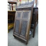 A Victorian Gothic Revival carved oak two door wall hanging cabinet, manner of A.W.N. Pugin, 89cms h