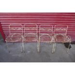 A set of four Victorian painted wrought iron garden chairs