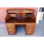 An American walnut tambour roll top desk, 131cms h, 140cms w, 82cms d