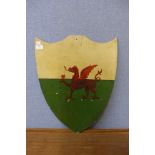 A painted shield shaped armorial plaque