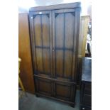 An early 20th Century oak press cupboard, 191cms h, 88cms w, 50cms d