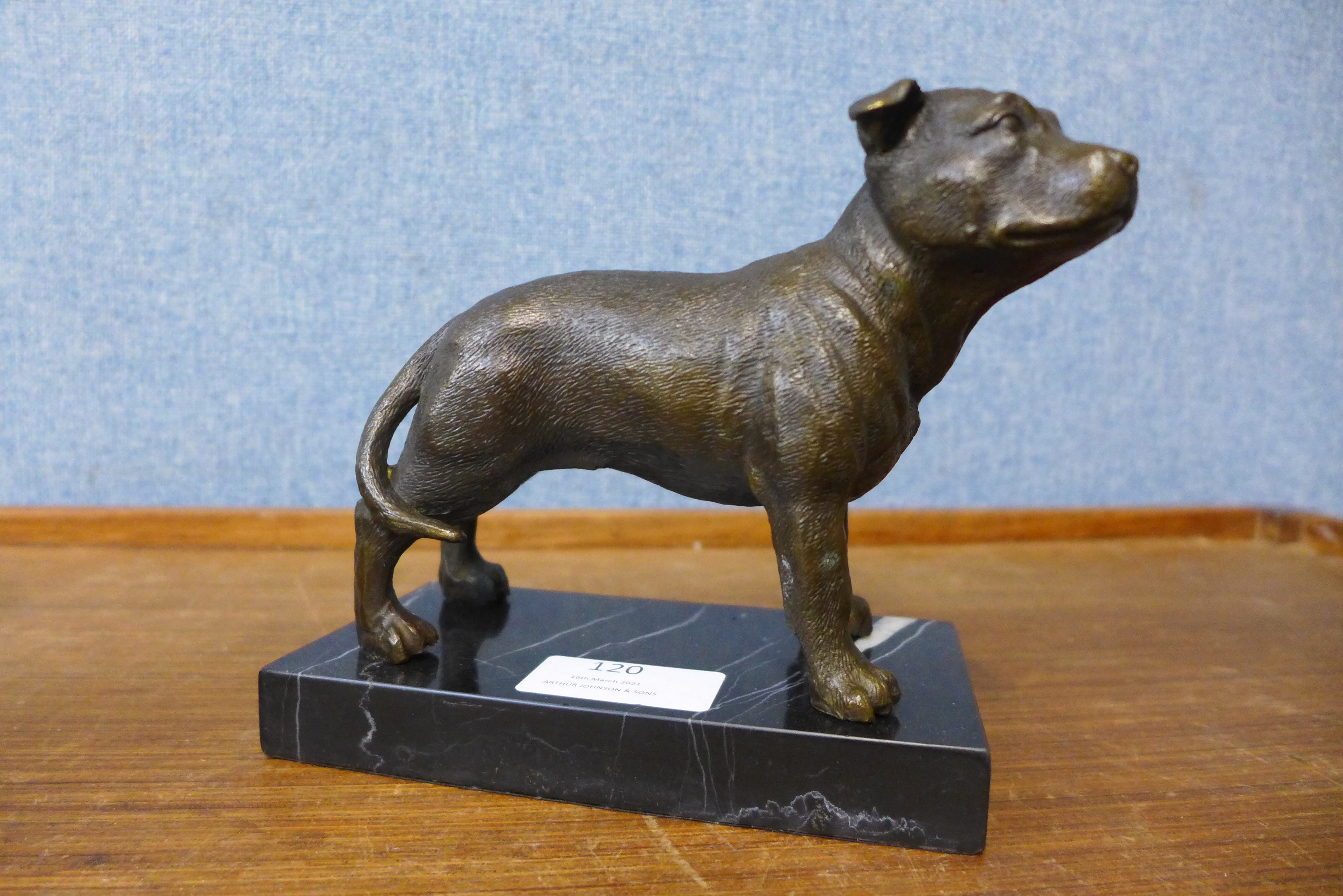 A bronze figure of a Staffordshire bull terrier, on black marble socle, 13cms h