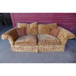 A Duresta style red and gold fabric upholstered settee, 73cms h, 218cms w, 115cms d