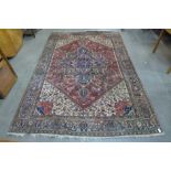 An eastern geometric pattern red ground rug, 293 x 200cms