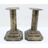 A pair of silver candlesticks, 114mm, weighted