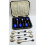 A set of six silver and blue enamel coffee bean spoons, (enamel chipped on two) and a cased set of