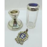 A silver candlestick, a large silver and enamel lodge medal, loop repaired, and a silver topped
