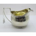 A George III silver cream jug, London 1810, Peter & William Bateman, with monogram, 113g