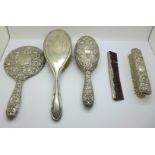 A four piece silver brush, comb and mirror set and a silver backed brush