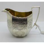 A George III silver cream jug with gilt interior, London 1802, 160g