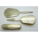 A three piece Art Deco silver brush and mirror set