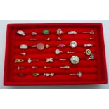 Thirty-four costume rings in a display box