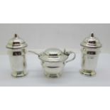 A three piece silver condiment set, mustard with blue glass liner, E. Viners, Sheffield 1937, silver