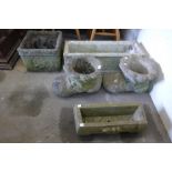 A pair of concrete boot shaped garden planters and four others