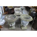 A pair of concrete campana shaped garden urns