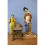 Two Japanese dolls and a carved wood lamp