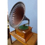 An oak gramophone with metal horn speaker