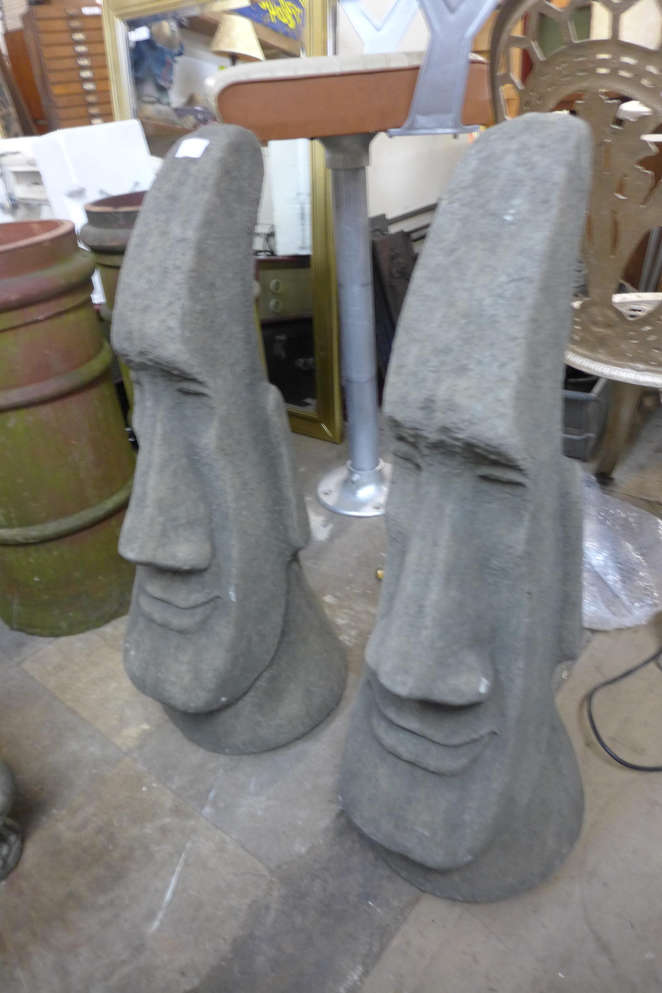 A pair of concrete garden figures of Easter Island style heads, 74cm h