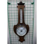 An Edward VII rosewood and marquetry inlaid shield shaped aneroid barometer