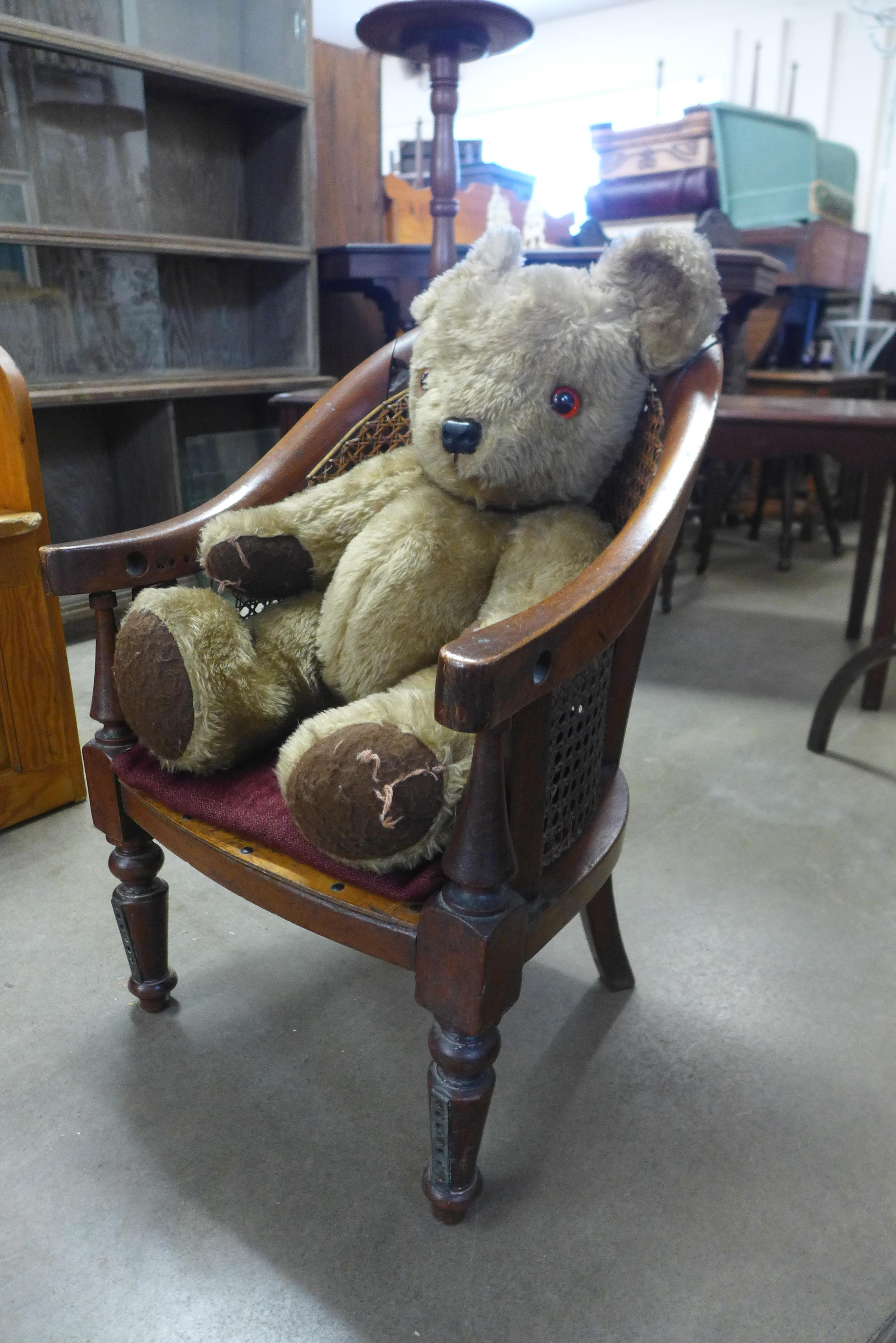 A vintage Teddy bear and chair